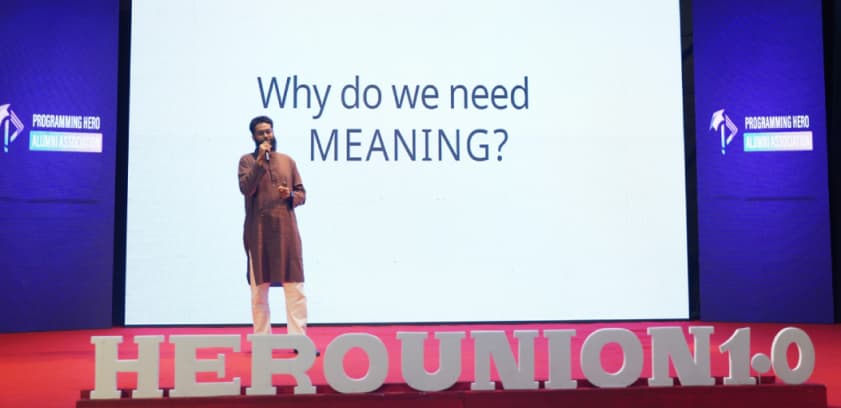 Speaker on stage at HEROUNION 1.0 with Programming Hero Alumni Association branding